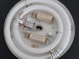 an overhead view of a white light fixture with wires and electronic components