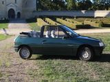 a green car that is parked in front of a castle