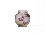 a small vase with a painting on it sitting on a table