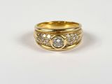 a close up of a gold ring with diamonds on it