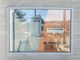 a picture of a picture of a storefront with a reflection of a building