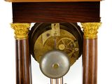 a clock that is sitting on top of a wooden table