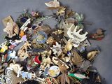 a pile of assorted brooches and other items on a table