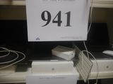 a sign on a shelf with a keyboard and mouse on it