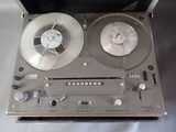 a silver tape recorder sitting on top of a table