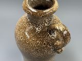 a brown vase that is sitting on a table