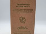 a cardboard box with a picture of a plant in it