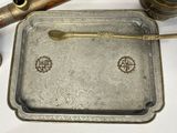 a silver tray with a spoon and spoon rest on it