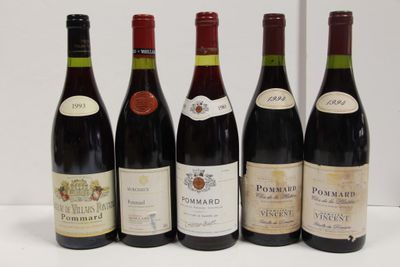 six bottles of red wine are lined up on a table