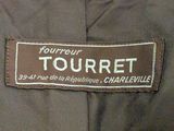 an image of a label on a jacket that says tourret