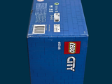 a box of legos sitting on a blue surface