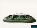 the green purse has two metal handles and a chain on it