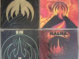 four cd ' s of various albums, including the band ' s logo