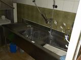a kitchen with a sink and a counter with a faucet in it