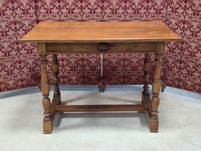 a small wooden table with a drawer underneath it