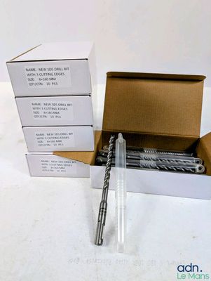 a box of drill bits sitting on a table next to a box of drill bits
