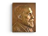 a bronze plaque of a man with a beard