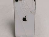 an apple iphone with a broken screen sitting on a table