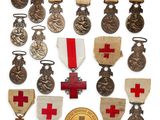 an assortment of medals and medals are displayed on a white surface
