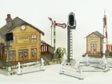 three miniature buildings that are next to each other