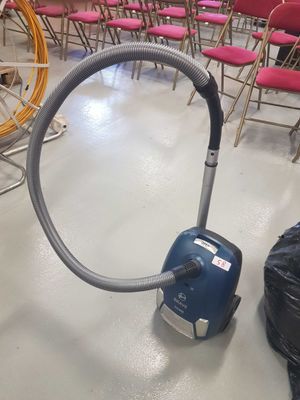 a vacuum that is sitting on the floor in a room