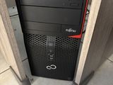 a computer tower with a keyboard on top of it