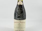 a close up of a bottle of wine on a white surface