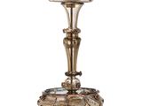 an antique silver plated candle holder with a flower design on it