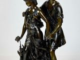 statue of a man and a woman with a dog on a white background