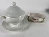a white bowl and saucer on a table next to a bowl