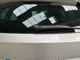 a white car parked in a parking lot next to a building