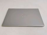 a laptop that is sitting on a white surface