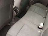 two seats in the back of a car with a cell phone in it