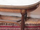a marble top table with a wooden base on a rug
