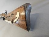 a wooden object with a bird on it on a white surface