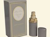 an image of a bottle of perfume sitting next to a box