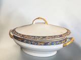 a close up of a bowl with a lid on a table