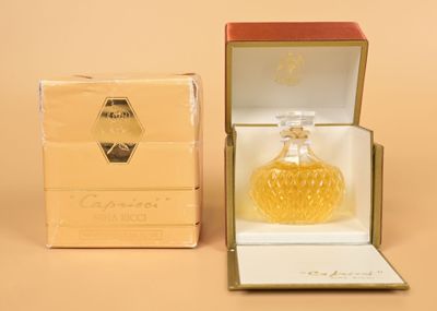 an image of a bottle of perfume sitting in a box on a table