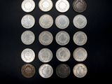 a close up of a bunch of coins on a black surface