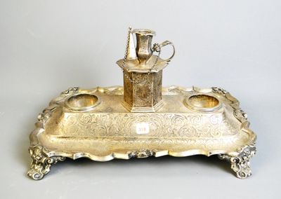 a silver tray with a silver pitcher on top of it