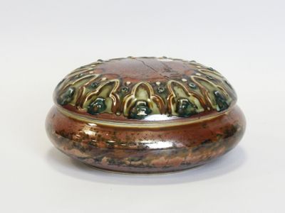 a brown and green box on a white surface