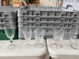 several empty wine glasses are sitting on a table in a warehouse