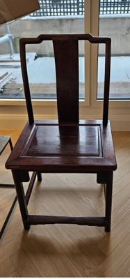 a wooden chair that is sitting in front of a window