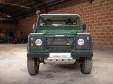 an image of a green land rover in a garage