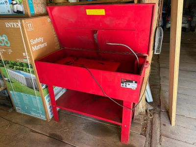 a red tool box sitting on top of a wooden table