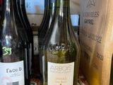 several bottles of wine are lined up on a table