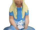 a figurine of a little girl sitting on the ground holding a teddy bear