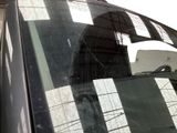a cat sitting on top of a car with its head out of the window