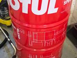 a red barrel with a brown pot sitting on top of it