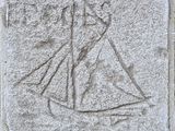 a close up of a stone with a drawing of a woman in a dress